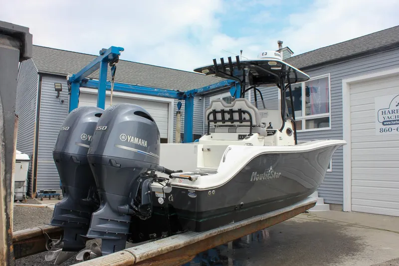 Slide: The Image of 2017 NauticStar 2602 Legacy boat in marina, featuring Yamaha engine. - 51