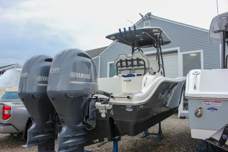 Slide: The Image of 2017 NauticStar 2602 Legacy boat docked at marina with twin engines. - 6