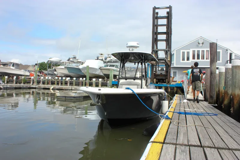Slide: The Image of 2017 NauticStar 2602 Legacy boat with dual Yamaha 150 engines, displayed outdoors. - 7