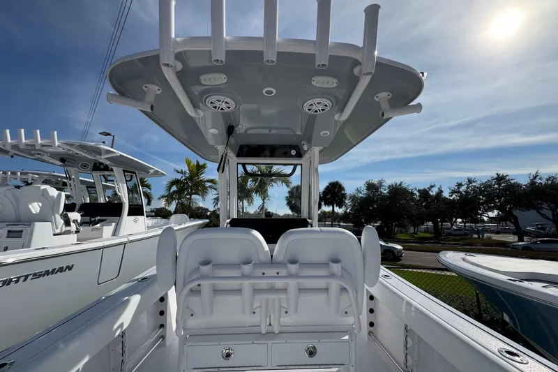 Slide: The Image of 2026 Sportsman Open 232 Center Console boat with T-top and seating, under a sunny sky. - 6