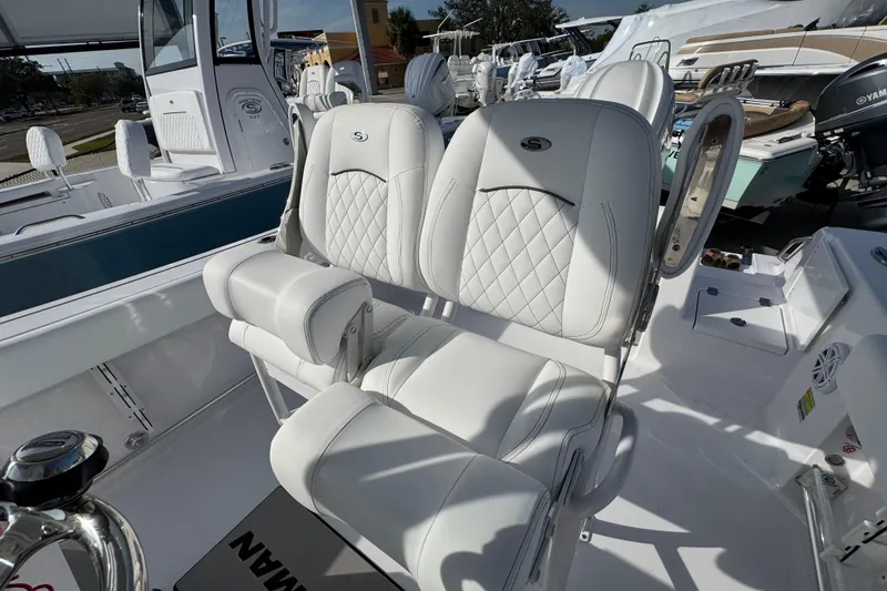 Slide: The Image of 2026 Sportsman Open 232 Center Console boat with luxurious white seating. - 9