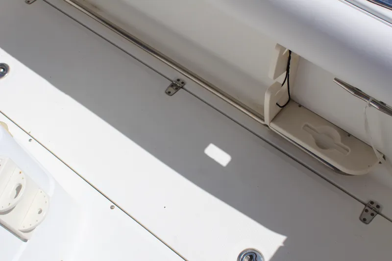 Slide: The Image of 2009 Boston Whaler 220 Outrage boat interior detail, showcasing storage compartment and deck features. - 10