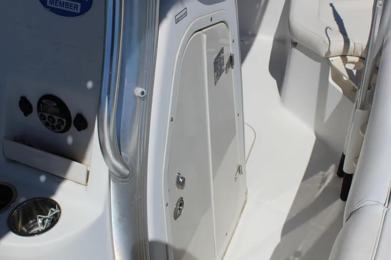 Slide: The Image of 2009 Boston Whaler 220 Outrage interior, featuring console and seating area. - 13