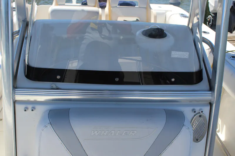 Slide: The Image of 2009 Boston Whaler 220 Outrage boat console with seating and steering wheel. - 17