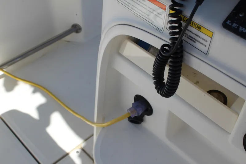 Slide: The Image of 2009 Boston Whaler 220 Outrage boat interior with yellow cable and control panel. - 21