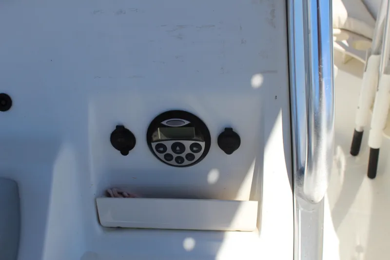Slide: The Image of Control panel on a 2009 Boston Whaler 220 Outrage boat, featuring a digital display. - 22