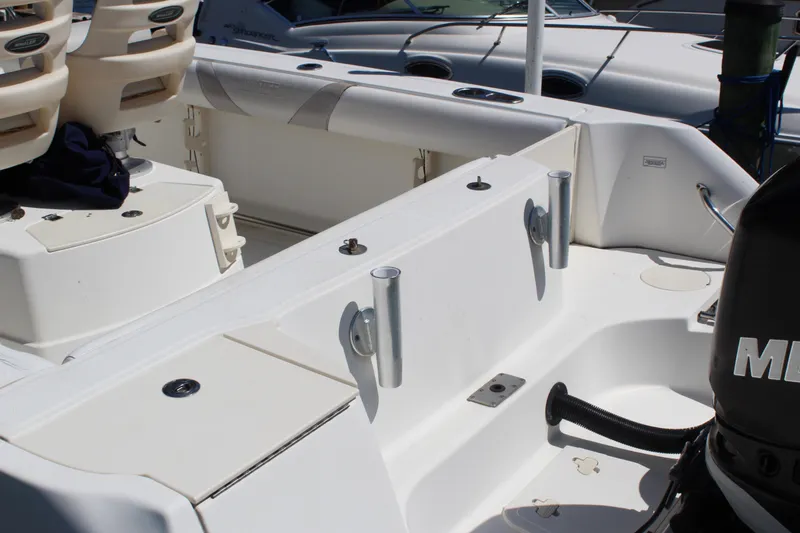 Slide: The Image of 2009 Boston Whaler 220 Outrage boat interior with seating and rod holders. - 5