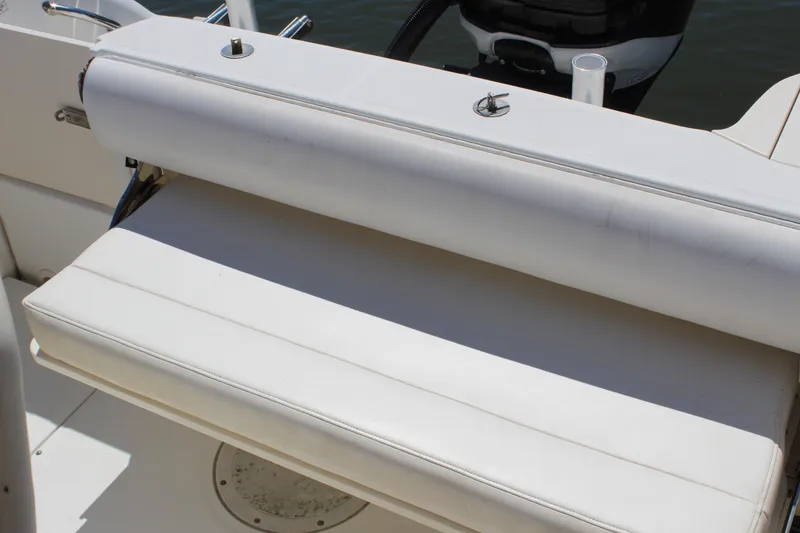 Slide: The Image of 2009 Boston Whaler 220 Outrage boat seat, white upholstery, close-up view. - 7