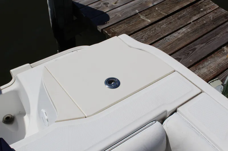 Slide: The Image of 2009 Boston Whaler 220 Outrage boat deck near wooden dock. - 8