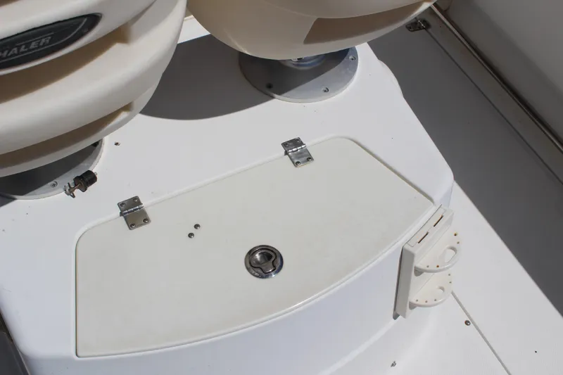 Slide: The Image of 2009 Boston Whaler 220 Outrage boat deck with storage compartment and seating. - 9