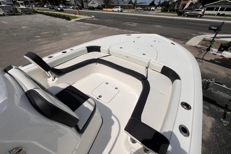 Slide: The Image of 2021 Tidewater 2500 Carolina Bay boat interior with cushioned seating and storage compartments. - 10