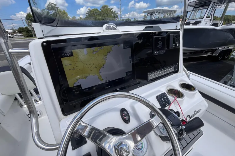 Slide: The Image of 2021 Tidewater 2500 Carolina Bay boat dashboard with navigation display and controls. - 15
