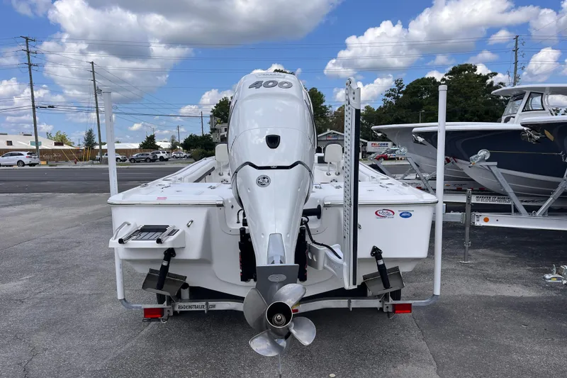 Slide: The Image of 2021 Tidewater 2500 Carolina Bay boat with powerful outboard motor, parked outdoors. - 3