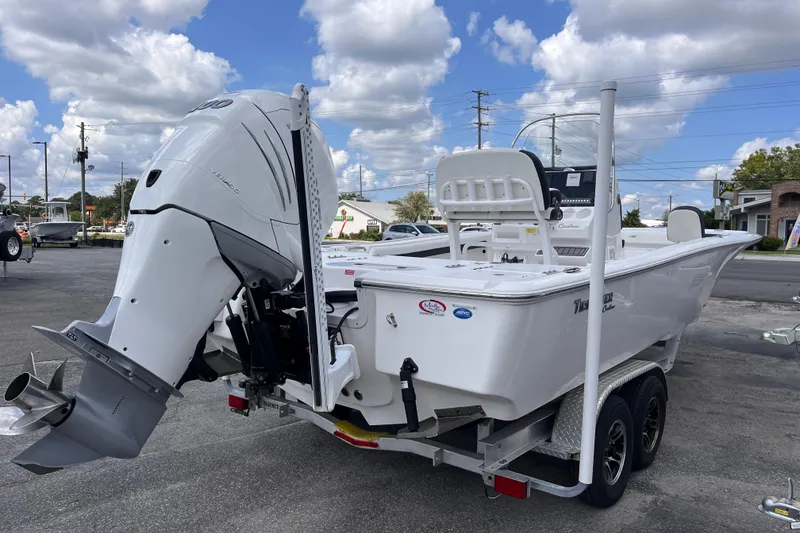 Slide: The Image of 2021 Tidewater 2500 Carolina Bay boat on trailer, featuring powerful outboard motor. - 4