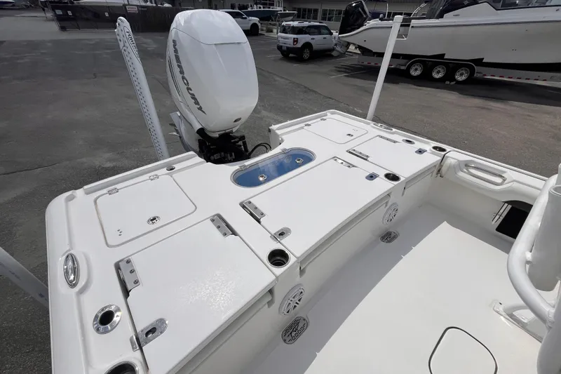 Slide: The Image of 2021 Tidewater 2500 Carolina Bay boat with Mercury engine, featuring spacious deck layout. - 5