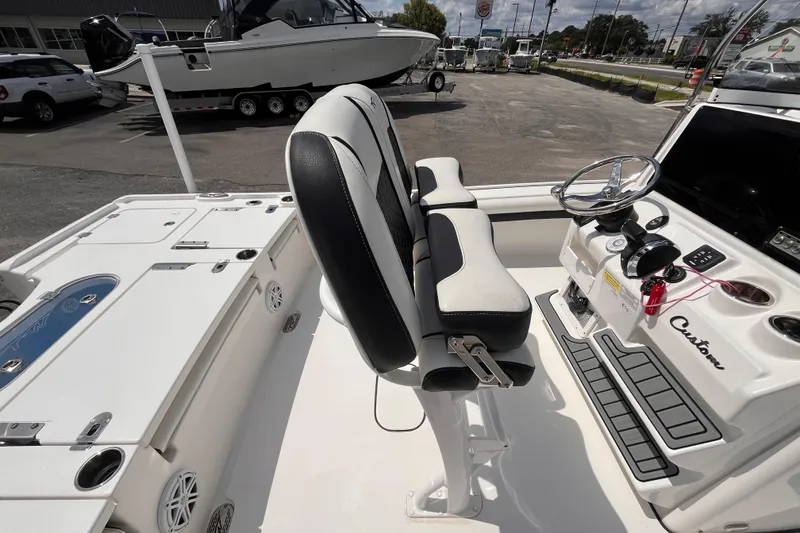 Slide: The Image of 2021 Tidewater 2500 Carolina Bay boat interior with steering console and seating. - 6