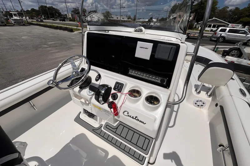 Slide: The Image of 2021 Tidewater 2500 Carolina Bay boat console with steering wheel and controls. - 7