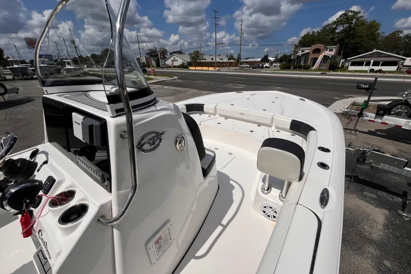 Slide: The Image of 2021 Tidewater 2500 Carolina Bay boat with sleek design, parked outdoors under a cloudy sky. - 8