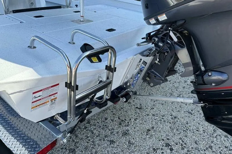 Slide: The Image of 2026 Xpress H20B Bay boat with motor and ladder on a trailer. - 12