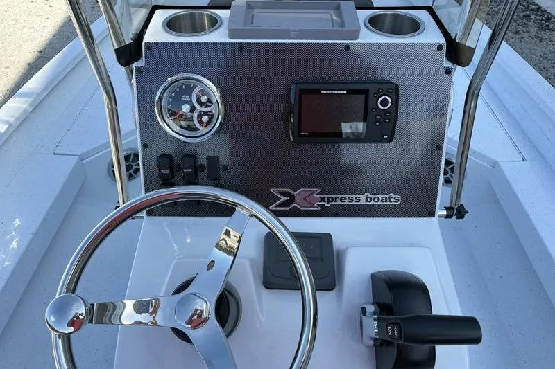 Slide: The Image of 2026 Xpress H20B Bay boat dashboard with steering wheel and control panel. - 14