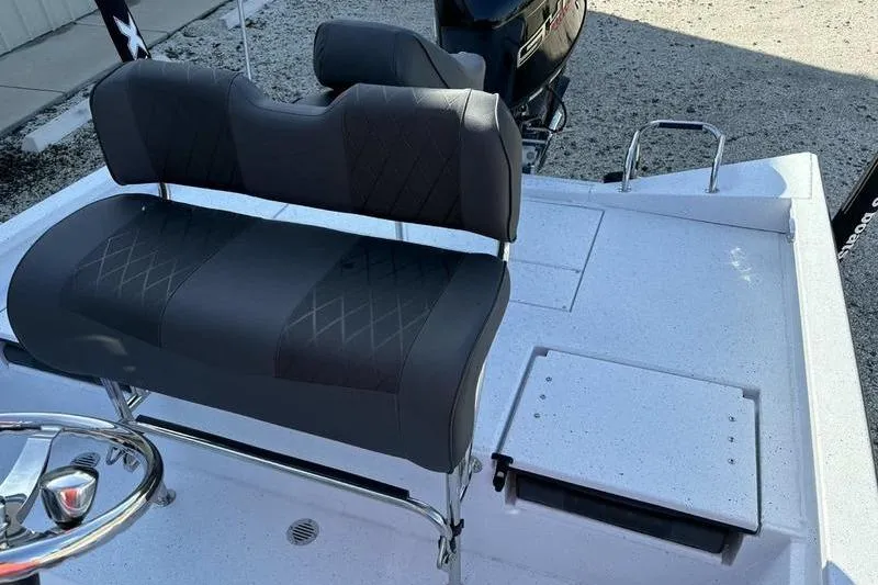 Slide: The Image of 2026 Xpress H20B Bay boat interior with cushioned seating and steering wheel. - 15