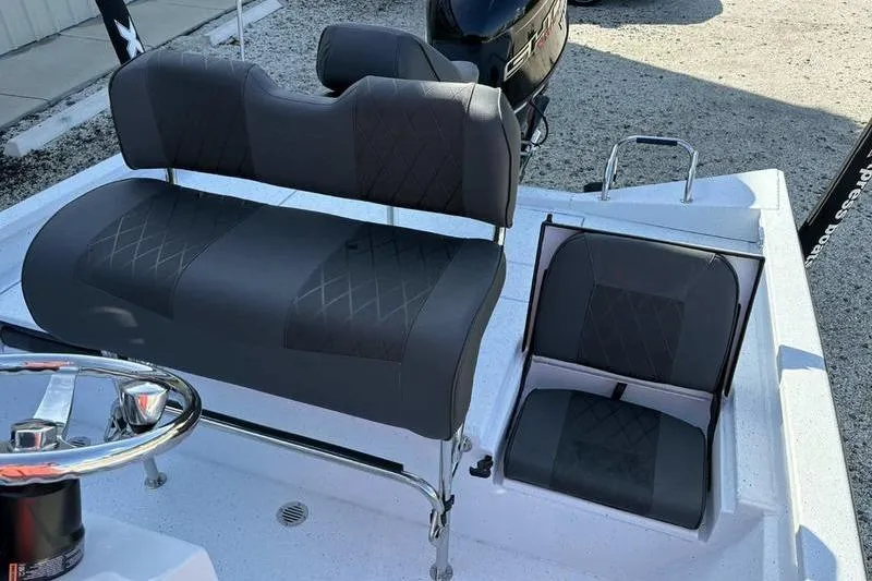 Slide: The Image of 2026 Xpress H20B Bay boat interior with gray seating and steering wheel. - 9