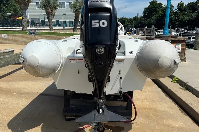 Slide: The Image of 2017 Mercury Inflatables M 400 HP boat with 50 HP engine, docked outdoors. - 4