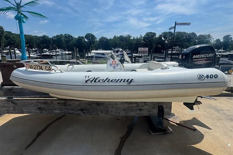 Slide: The Image of 2017 Mercury Inflatables M 400 HP boat docked at a marina under clear skies. - 6