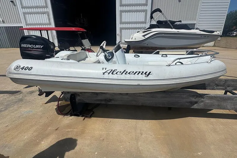 Slide: The Image of 2017 Mercury Inflatables M 400 HP boat on a trailer, labeled "Alchemy." - 1
