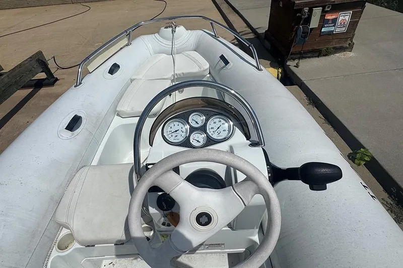 Slide: The Image of 2017 Mercury Inflatables M 400 HP boat with steering wheel and dashboard controls. - 3