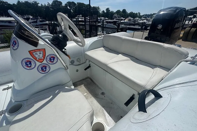 Slide: The Image of 2017 Mercury Inflatables M 400 HP boat interior with white seating and steering wheel. - 8