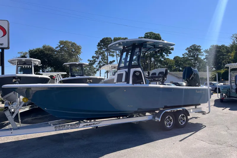 Slide: The Image of 2026 Tidewater 2500 Carolina Bay boat on trailer, displayed outdoors under clear sky. - 1