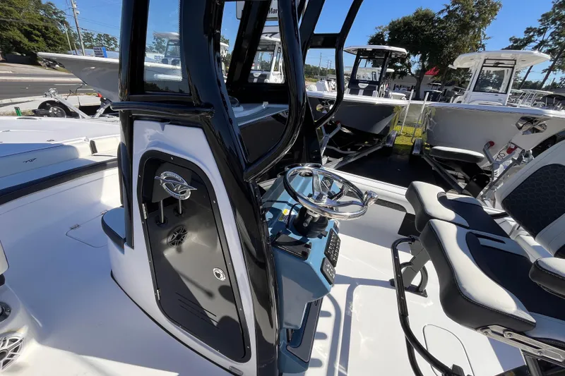 Slide: The Image of 2026 Tidewater 2500 Carolina Bay boat interior with steering wheel and seating. - 15