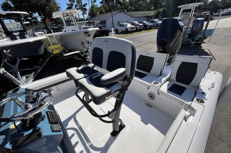 Slide: The Image of 2026 Tidewater 2500 Carolina Bay boat interior with seating and steering wheel. - 16