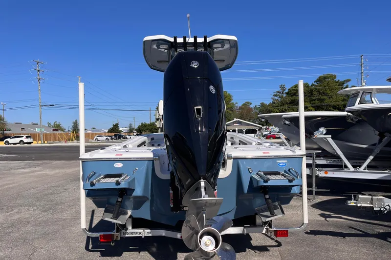 Slide: The Image of 2026 Tidewater 2500 Carolina Bay boat with powerful outboard motor, parked outdoors. - 3