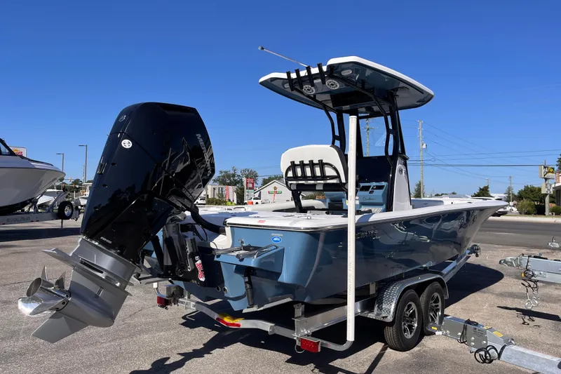 Slide: The Image of 2026 Tidewater 2500 Carolina Bay boat with powerful outboard motor on trailer. - 4