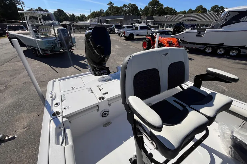 Slide: The Image of 2026 Tidewater 2500 Carolina Bay boat with dual seats and outboard motor in a showroom. - 6
