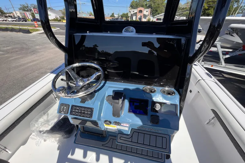 Slide: The Image of 2026 Tidewater 2500 Carolina Bay boat console with steering wheel and controls. - 9
