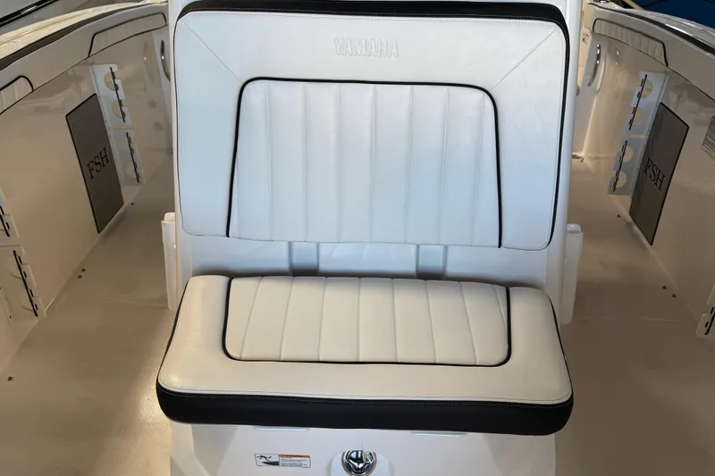 Slide: The Image of 2024 Yamaha Boats 252 FSH Sport interior seating with white and black upholstery. - 10