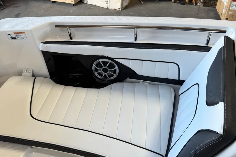 Slide: The Image of 2024 Yamaha Boats 252 FSH Sport interior with white seating and speaker detail. - 13