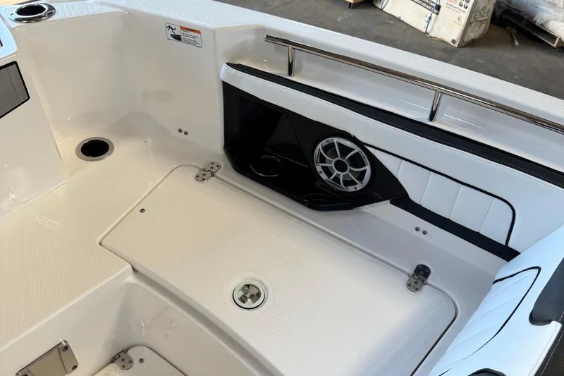 Slide: The Image of 2024 Yamaha Boats 252 FSH Sport interior with speaker and storage compartment. - 14