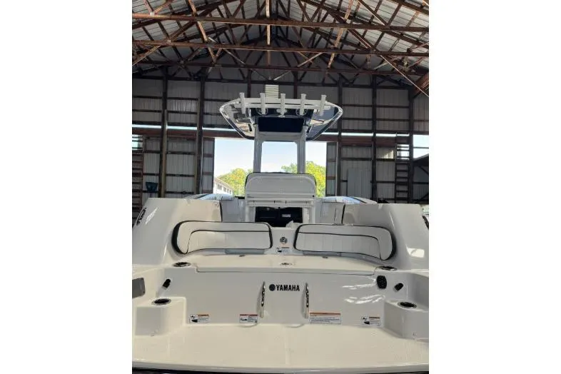 Slide: The Image of 2024 Yamaha Boats 252 FSH Sport in a warehouse, rear view. - 2