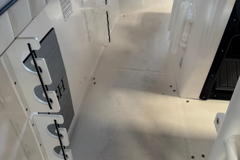 Slide: The Image of 2024 Yamaha Boats 252 FSH Sport interior deck with rod holders and storage compartments. - 5