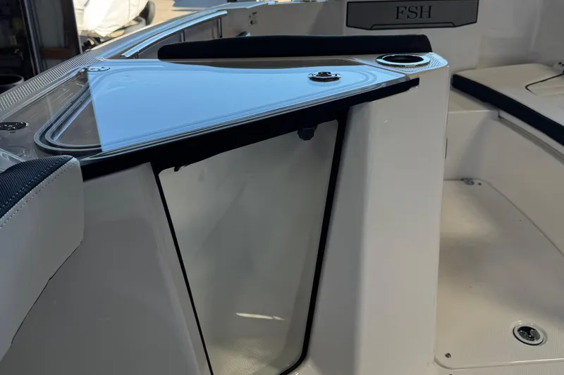 Slide: The Image of 2024 Yamaha Boats 252 FSH Sport interior detail with sleek design and cup holder. - 7