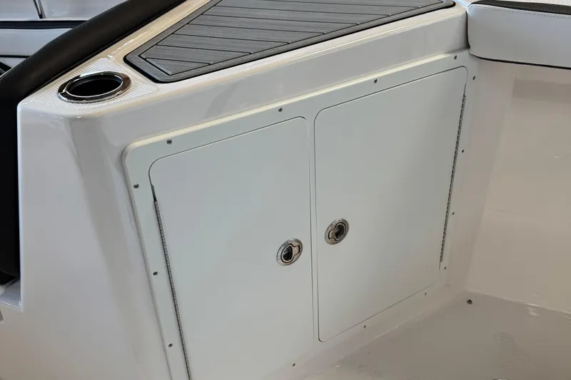 Slide: The Image of 2024 Yamaha Boats 252 FSH Sport storage compartment with cup holder and sleek design. - 8