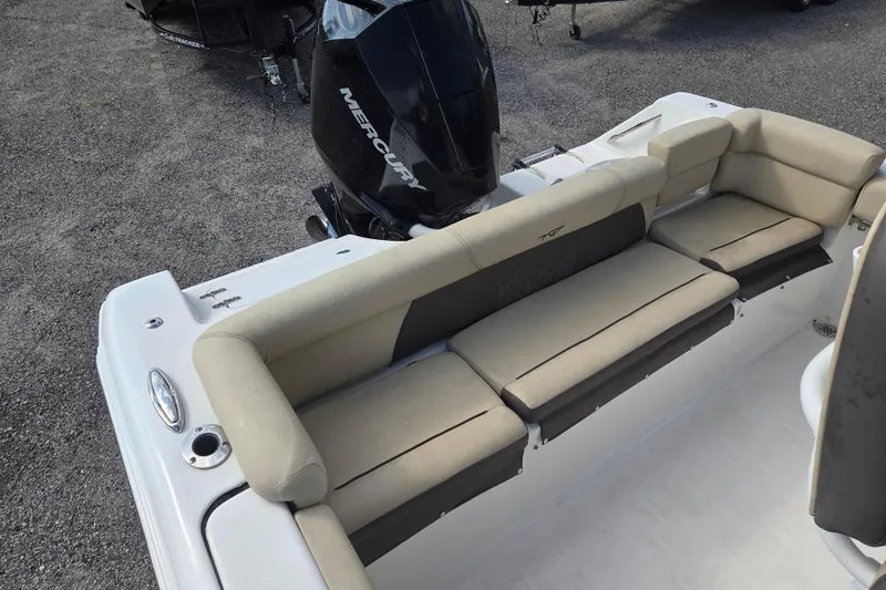 Slide: The Image of 2021 Tidewater 220 LXF boat interior with beige seating and Mercury outboard motor. - 14