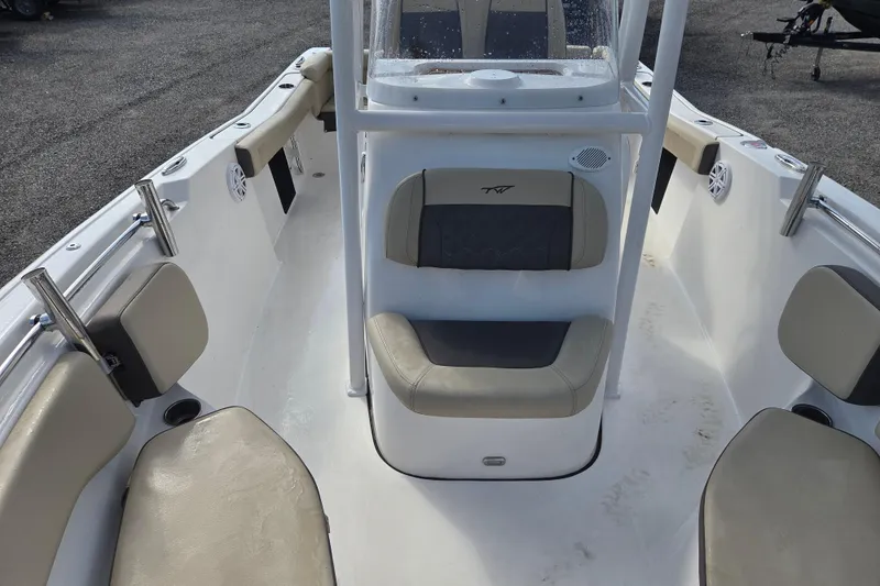 Slide: The Image of 2021 Tidewater 220 LXF boat interior with cushioned seating and rod holders. - 17