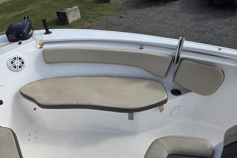 Slide: The Image of 2021 Tidewater 220 LXF boat interior with cushioned seating and speaker. - 18