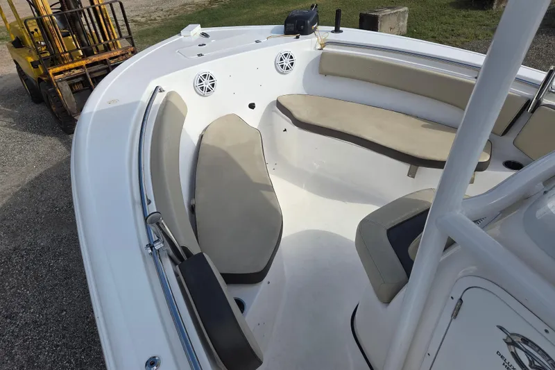 Slide: The Image of 2021 Tidewater 220 LXF boat interior with beige seating and white deck. - 19