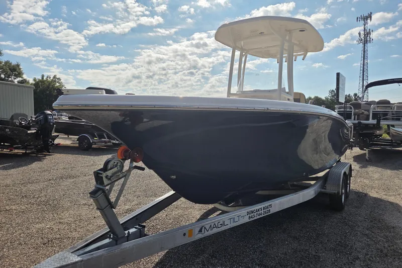 Slide: The Image of 2021 Tidewater 220 LXF boat on trailer under a partly cloudy sky. - 2